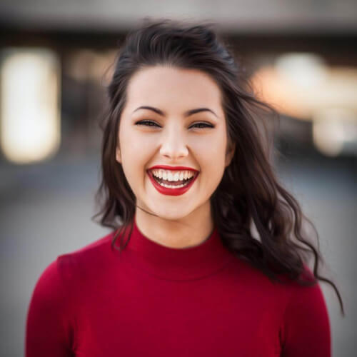 close up photo smiling woman with red top
